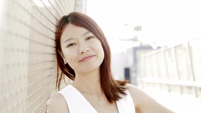 lifestyle portrait of young cute asian women looking at camera. city people view