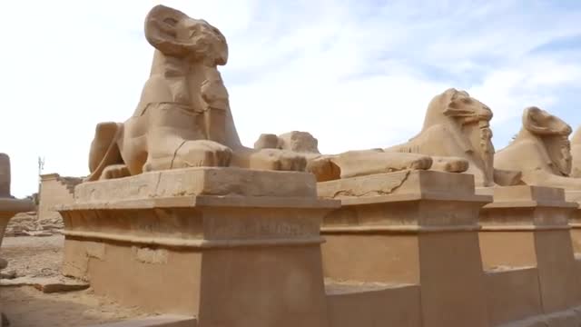 Statues of Sheeps Against Cloudy Sky