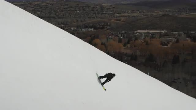 Snowboarder Hits Big Air in Halfpipe