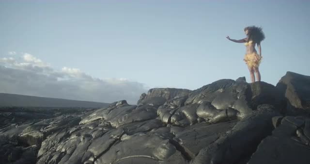 Woman Standing over Lava Formation
