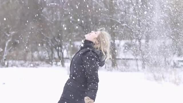 blond women playing in snow winter time slow motion