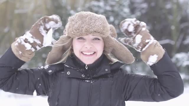 happy women enjoying winter time snow slow motion