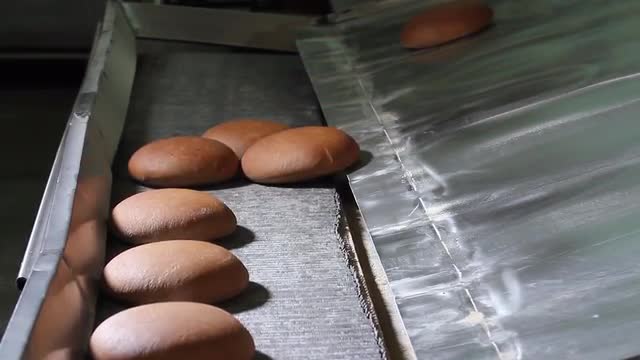 Freshly baked bread comes out of the oven