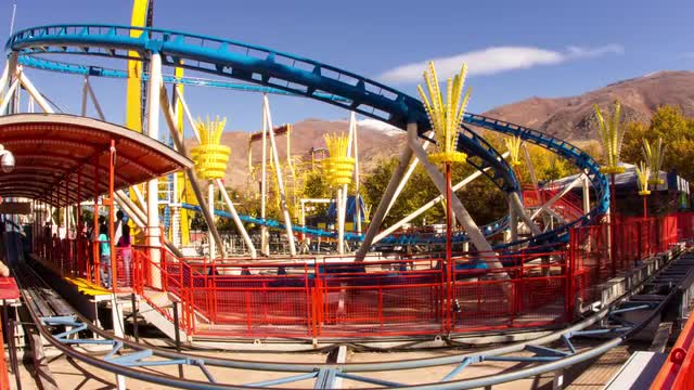 A fisheye view of the holding area where people gather for a roller coaster ride.