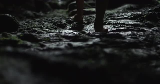 Woman walking on cave floor