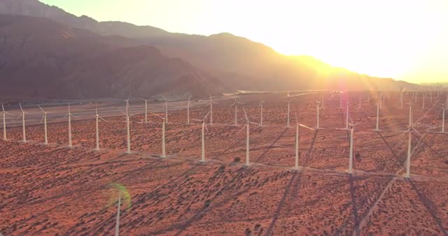 Aerial View Windmill Turbines Producing Clean Sustainable Energy At Sunset   