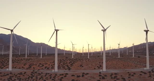 Aerial View Windmill Turbines Producing Clean Sustainable Energy At Sunset
