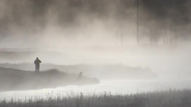 Fly fishermen fishing in fog
