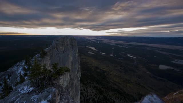 Sunrise from tall mountain on edge of the prairies 