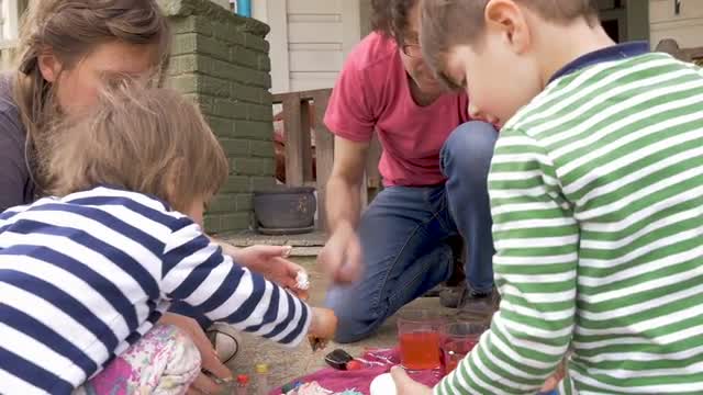 Young family with children working on a fun arts and crafts project together