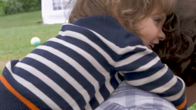 Young 2 - 3 year old girl hugging father getting ready for a piggyback ride