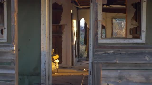 Abandoned dilapidated wood house with old furniture and broken window dolly