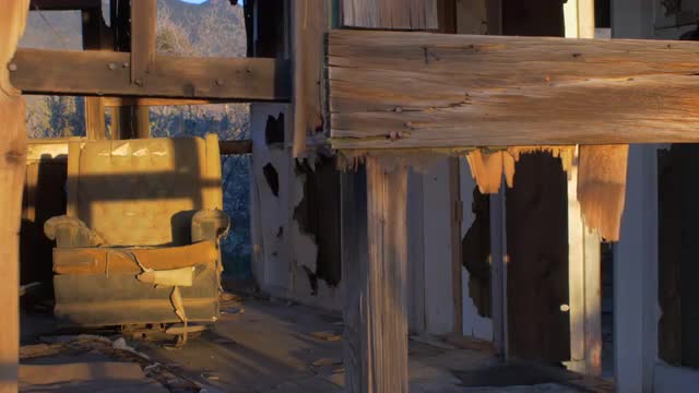 Abandoned dilapidated wood house with old ruined chair and broken window