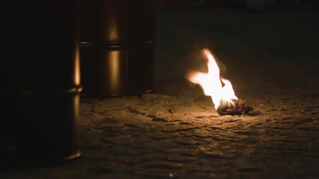 Piece of Rope Burns in the Night on the Pavement