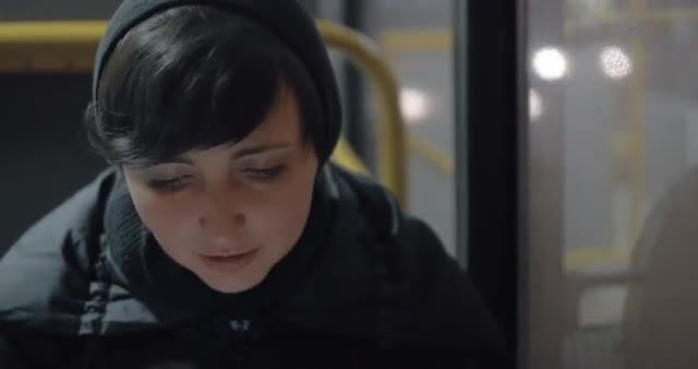 Woman commuter with mobile in the bus