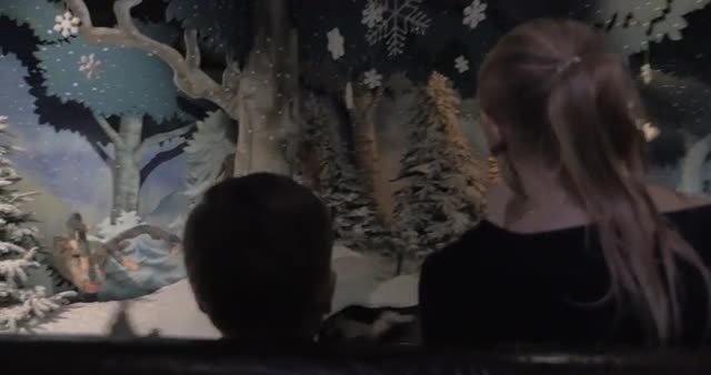 Mom and child having a ride in indoor amusement park