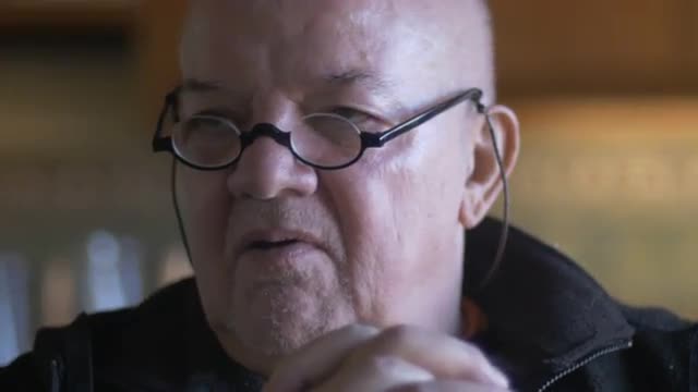 Closeup of an elderly gentleman shaking his head and saying no