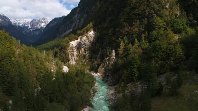 Aerial view of the Soca River flowing out from steep canyon