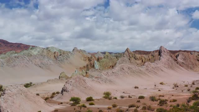 Rock formations, bushes and clouds