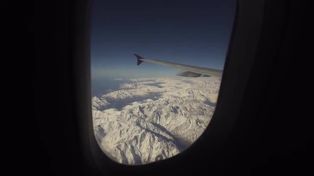 View from airplane window on mountains.