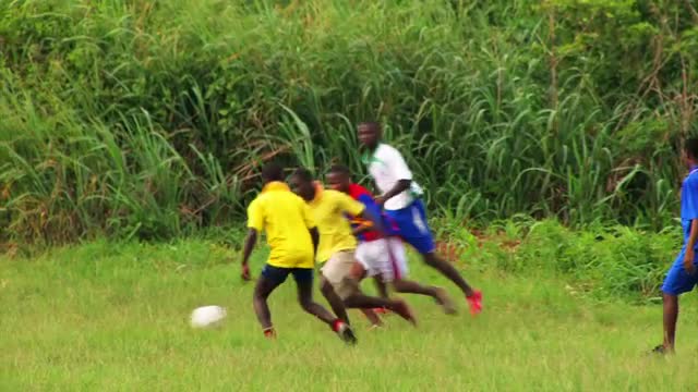 African children playing soccer.