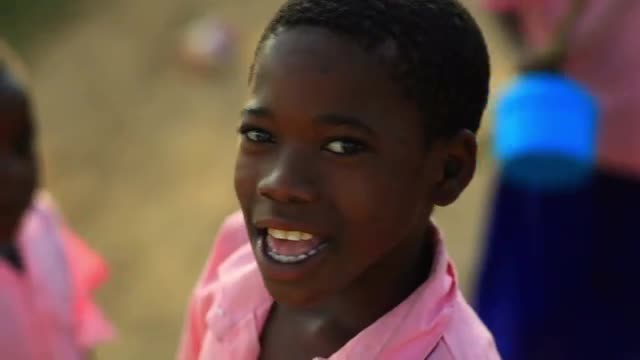 Kenyan girl smiling at the camera.