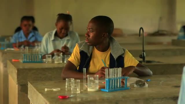 Student doing chemistry in Kenya.