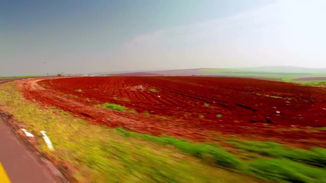 Stock Video Footage drive-by of a furrowed field in Israel.