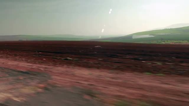 Stock Video Footage drive-by of a freshly plowed field in Israel.