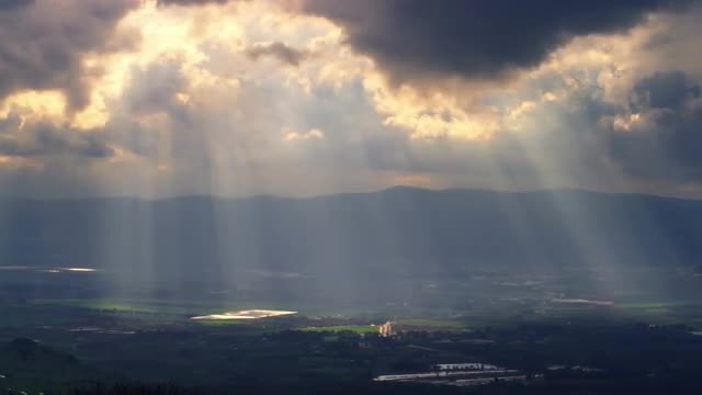Stock Video Footage panorama of sun rays illuminating a valley shot in Israel at 4k with Red.