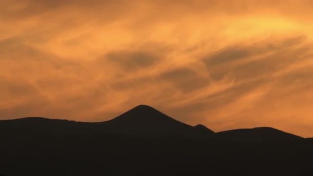 Clouds lit by sunset and silhouetted mountains shot in Israel.