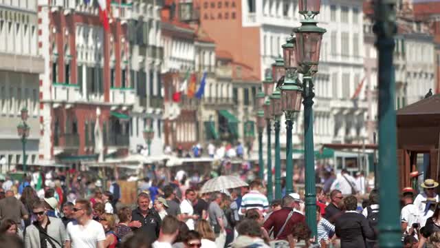 Slow motion shot of people walking with racking focus