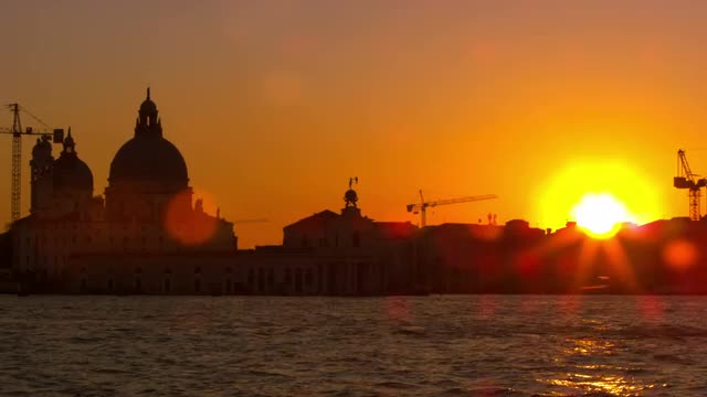 Lens flare shot of setting sun with the Santa Maria della Salute.