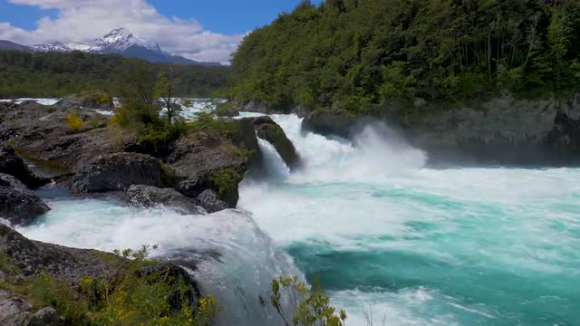 Petrohue waterfalls with the Osorno and Calvuco volcanoes