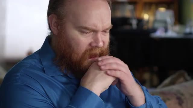 Man looking sad as he puts his hand on his face