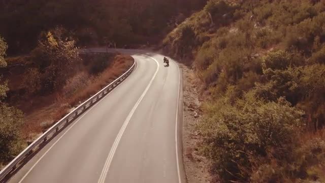 Aerial Shot Extreme Motorcyclist Riding Sport Bike Motorcycle on Curvy Road Filmed From Above 