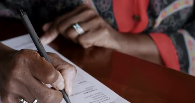 Attractive black woman filling out a diabetes medical history form