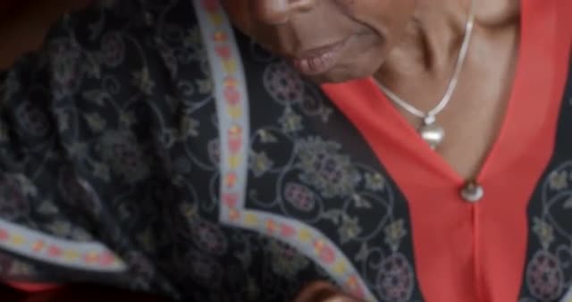 Senior black woman over 50 filling out medical history form about pain