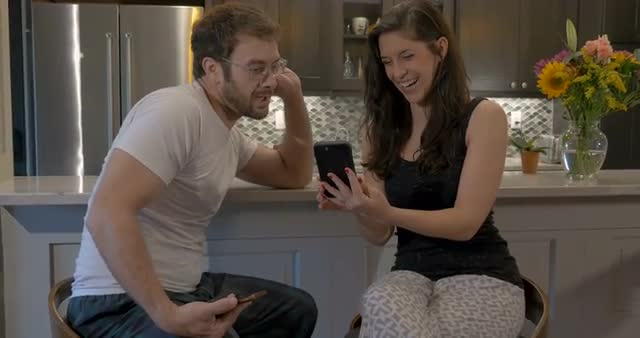 Beautiful couple talking and having fun with their smart phone technology apps