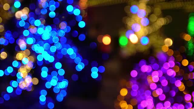 Out of focus holiday lights at night during Christmas time.