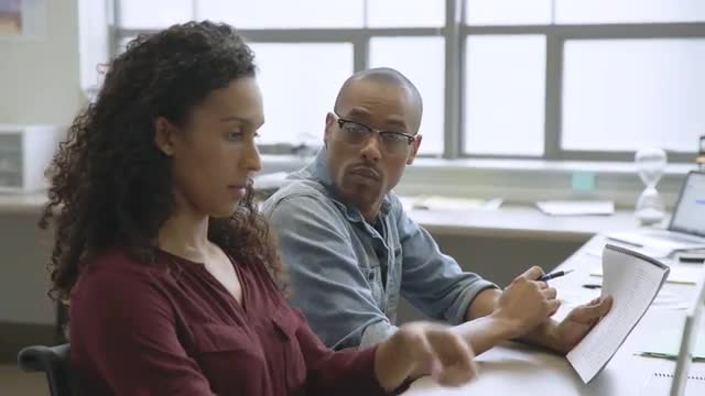 Business people discussing paperwork in startup office