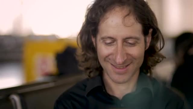 Man looking at his smart phone gets good news and pumps his arm celebrating