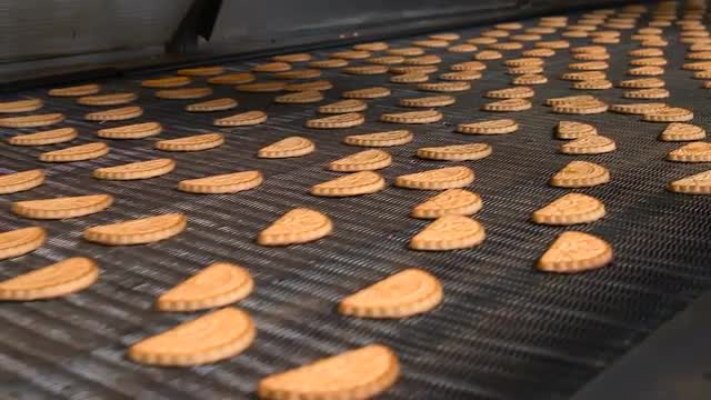 Freshly baked shortbread cookies leave the oven.