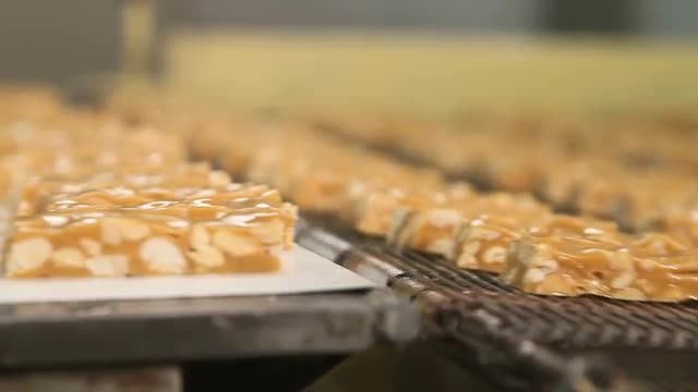 Bars of nougat with peanuts on the production line