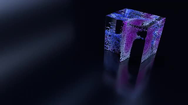Particles swirl around inside a glass cube.