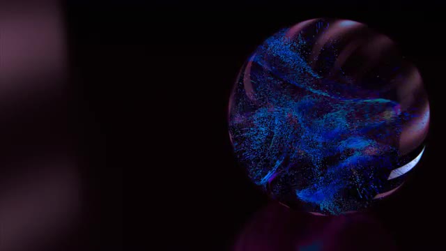 Color changing / flashing particles swirl around inside a glass sphere.