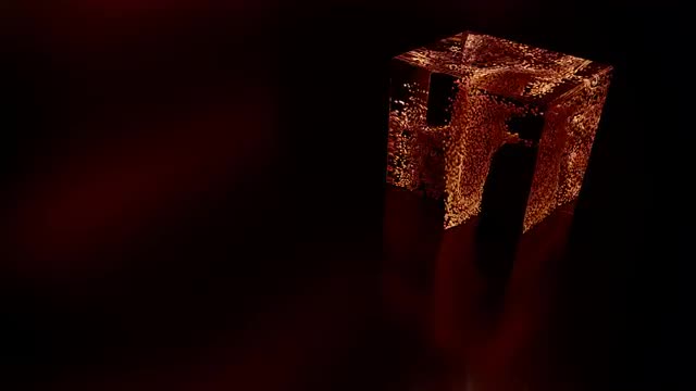 Particles swirl around inside a glass cube.