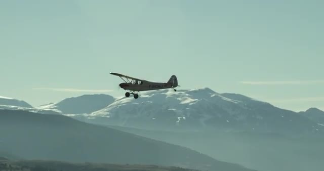 Plane flying over a small village - MEDIUM SHOT
