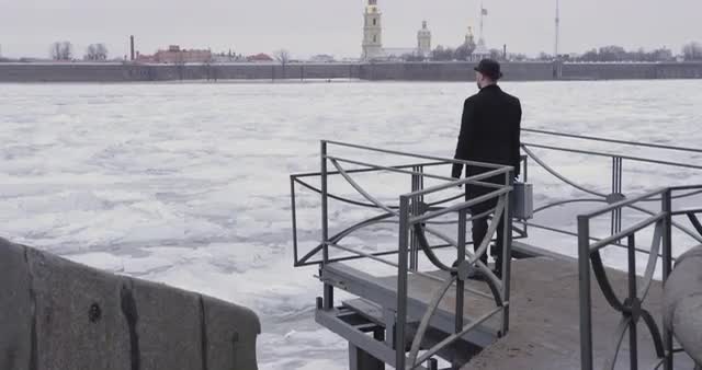 Man with case near river