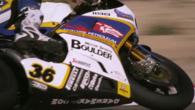 Slow motion video of motorcycle racers competing at the race track